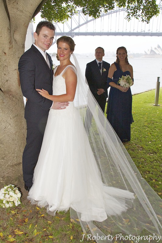 Couple with their attendants and Sydney Harbour Bridge behind - wedding photography sydney